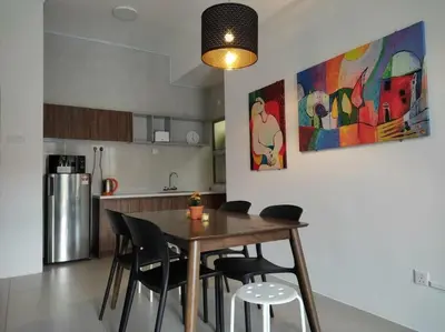 a kitchen with a wooden table and chairs in a room at The Gallery Camerons, cosy for the whole family in Brinchang