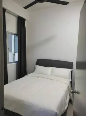 a bedroom with a white bed with a window at The Gallery Camerons, cosy for the whole family in Brinchang