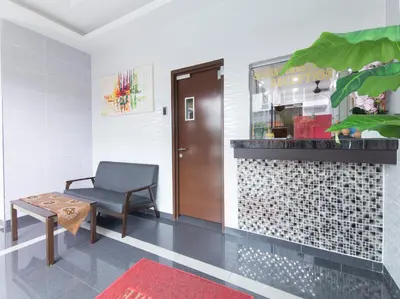 a waiting room with a chair and a table at Silibin Times Inn Hotel in Ipoh