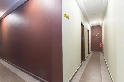 a corridor in a hospital with a brown wall at Silibin Times Inn Hotel in Ipoh