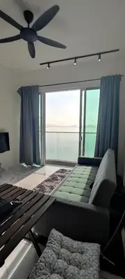 a bedroom with a couch and a ceiling fan at Infinite Seaview with Penang Bridge Suite with Sunrise up to 11 person in Bayan Lepas
