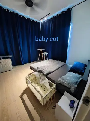 a bedroom with two beds and a baby crib at Infinite Seaview with Penang Bridge Suite with Sunrise up to 11 person in Bayan Lepas