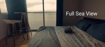 a bedroom with a bed with a full sea view at Infinite Seaview with Penang Bridge Suite with Sunrise up to 11 person in Bayan Lepas