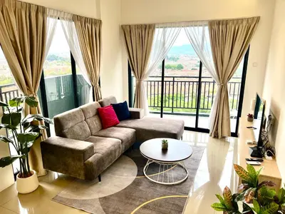 a living room with a couch and a table at Ipoh Tambun Cove Luxe Premium Suites in Ipoh