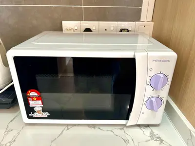 a white microwave oven sitting on top of a counter at Ipoh Tambun Cove Luxe Premium Suites in Ipoh