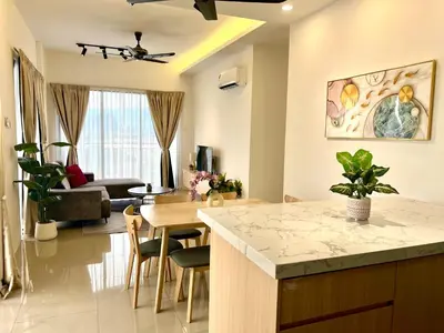 a kitchen and living room with a table and chairs at Ipoh Tambun Cove Luxe Premium Suites in Ipoh