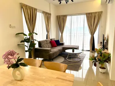 a living room with a couch and a table at Ipoh Tambun Cove Luxe Premium Suites in Ipoh