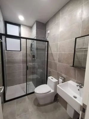 a bathroom with a toilet and a shower and a sink at Ipoh Tambun Cove Luxe Premium Suites in Ipoh