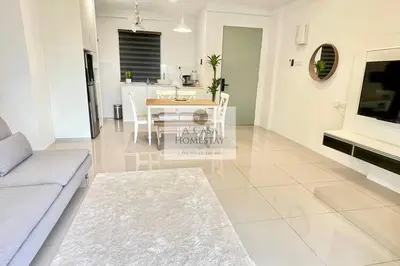 a living room with a couch and a dining room at A' Casa Homestay Ipoh Perak in Ipoh