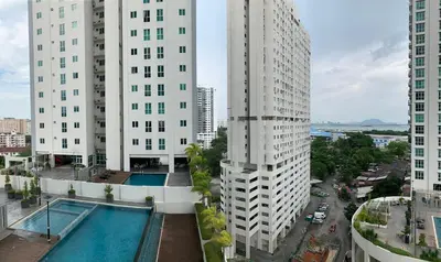 a view of two tall buildings and a swimming pool at Straits Garden Suites by Yen's Sojourn in George Town