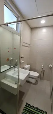 a bathroom with a sink and a toilet at Straits Garden Suites by Yen's Sojourn in George Town