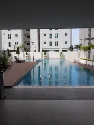 a large swimming pool in the middle of a building at Straits Garden Suites by Yen's Sojourn in George Town