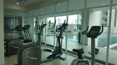 a gym with rows of exercise bikes in a building at Straits Garden Suites by Yen's Sojourn in George Town