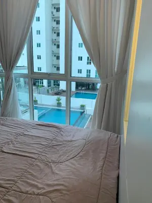 a bedroom with a bed and a large window at Straits Garden Suites by Yen's Sojourn in George Town