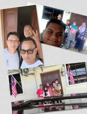 a group of people standing in front of a house at Homestay D'Art Container in Balik Pulau