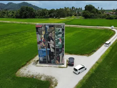 a car parked in front of a building with a painting at Homestay D'Art Container in Balik Pulau