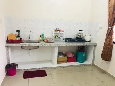 a kitchen with a sink and a counter top at Homestay D'Art Container in Balik Pulau