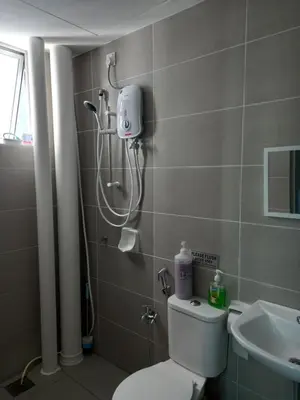 a bathroom with a shower and a toilet and a sink at SAFIYYA HOMES MERU RAYA - WIFI/NETFLIX in Ipoh