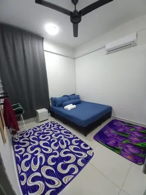 a bedroom with a blue bed and a rug at SAFIYYA HOMES MERU RAYA - WIFI/NETFLIX in Ipoh