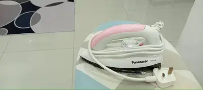 a pink and white hair dryer sitting on a table at D'NAS HOMESTAY - Muslm Only in Sungai Besar