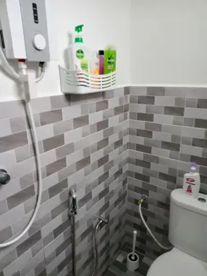 a bathroom with a shower and a toilet in it at D'NAS HOMESTAY - Muslm Only in Sungai Besar