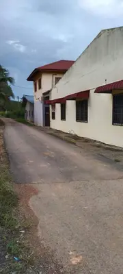 an empty road next to a white building at Sobey Laris Homestay CHIKU1 in Gua Musang