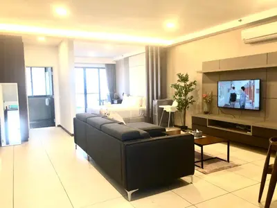 a living room with a couch and a tv at Seaview Water Purify Cozy Comfortable for Short & Long Stay in The Landmark by Katana in George Town