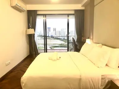 a hotel room with a bed with a stuffed animal on it at Seaview Water Purify Cozy Comfortable for Short & Long Stay in The Landmark by Katana in George Town