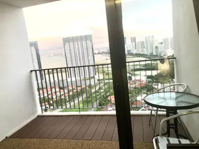 a balcony with a table and a view of the city at Seaview Water Purify Cozy Comfortable for Short & Long Stay in The Landmark by Katana in George Town