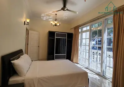 a bedroom with a bed and a large window at 99 Kelawei in George Town