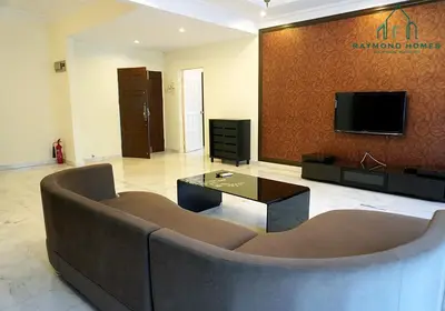 a large living room with a couch and a tv at 99 Kelawei in George Town