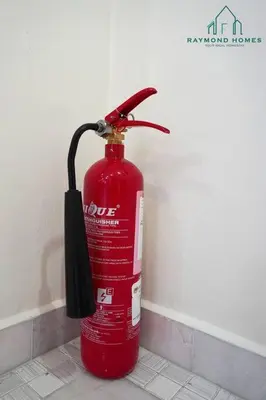 a red fire hydrant with an umbrella attached to a wall at 99 Kelawei in George Town