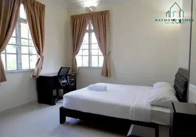 a bedroom with a bed and a desk and two windows at 99 Kelawei in George Town