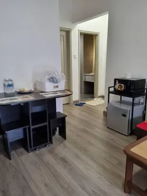 a living room with a table and a stove at Copthorn Homestay in Brinchang