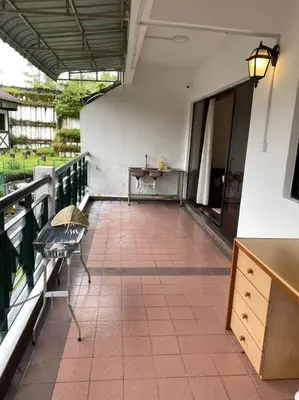 a balcony with a table and a sink and a desk at Copthorn Homestay in Brinchang