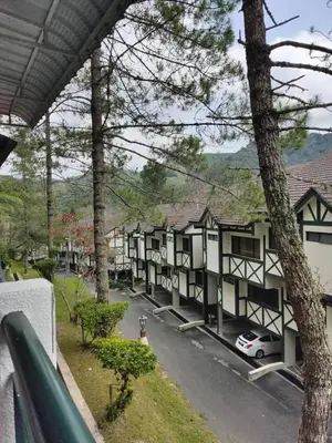 a row of houses with a car parked in a parking lot at Copthorn Homestay in Brinchang