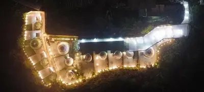 a building is lit up at night with lights at Glamz Hills in Cameron Highlands
