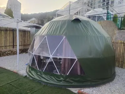a green dome tent sitting on the grass at Glamz Hills in Cameron Highlands