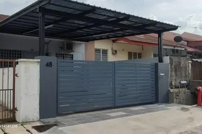 a blue gate in front of a house at Margosa Botani Ipoh Homestay 3BR by Grab A Stay in Ipoh