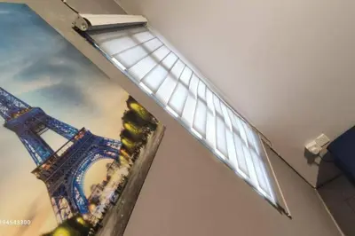 a light on a wall with a picture of the eiffel tower at Margosa Botani Ipoh Homestay 3BR by Grab A Stay in Ipoh