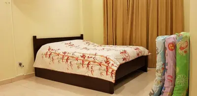 a bedroom with a bed and a window with a bedspread at Crown Imperial Court Apartment (Madam Ng)1 in Cameron Highlands