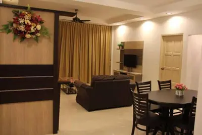a living room with a table and a couch at Crown Imperial Court Apartment (Madam Ng)1 in Cameron Highlands