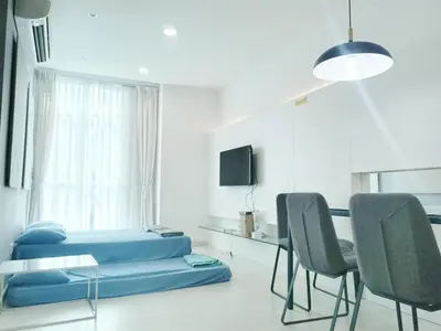 a room with a bed and a table and chairs at Deluxe Suites Stay, Netflix,2BR, in George Town