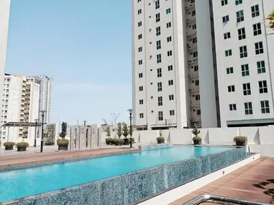 a swimming pool in the middle of two tall buildings at Deluxe Suites Stay, Netflix,2BR, in George Town