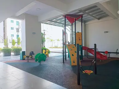 a play room with a playground with a slide at Deluxe Suites Stay, Netflix,2BR, in George Town