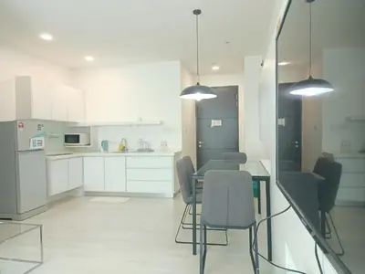 a kitchen with white cabinets and a table and chairs at Deluxe Suites Stay, Netflix,2BR, in George Town