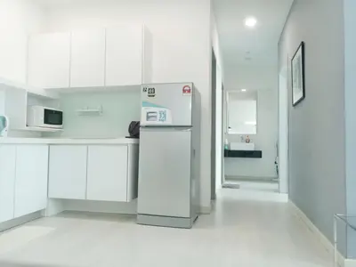 a kitchen with white cabinets and a refrigerator at Deluxe Suites Stay, Netflix,2BR, in George Town
