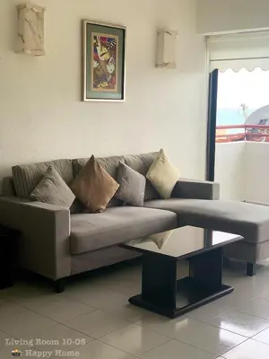a living room with a couch and a coffee table at Happy Home 10 Sri Sayang Batu Ferringhi in Batu Ferringhi