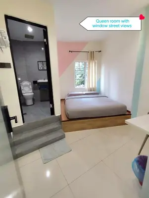 a view of a bedroom with a bed and a mirror at MUSANG ONG HOTEL in Cameron Highlands