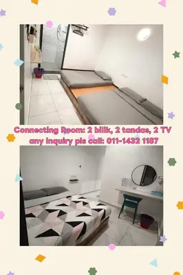 a room with two beds and a tv in it at MUSANG ONG HOTEL in Cameron Highlands